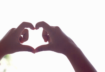 Fototapeta premium childern hands making sign Heart by fingers