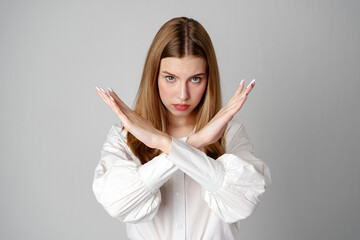 Young Woman Making X Sign With Arms to Express Prohibition or Disagreement
