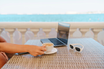 Woman coffee cafe macbook. Woman sitting at a coffee shop with mobile phone drinking coffee and...