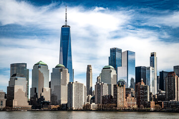 Witness the awe-inspiring panorama of New York City from the tranquil waters of the Hudson River. Iconic skyscrapers pierce the twilight sky.