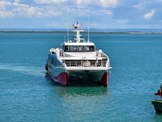Cebu City, Philippines - SeaCat Oasis, a catamaran ferry from Calbayog arriving at the port of Cebu during a sunny day.
