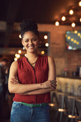 Crossed arms, smile and portrait of woman waitress in restaurant for hospitality career with pride. Happy, small business and female cafe owner with positive, good and confident attitude for job.