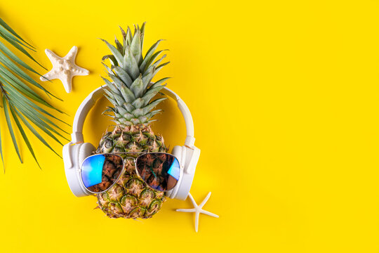 Sweet pineapple in sunglasses and headphones - Powered by Adobe
