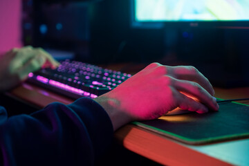 Close-up of a gamer's hand on a mouse, showcasing precision and control in gameplay