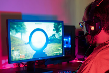 A gamer intensely focused on the screen, displaying serious concentration