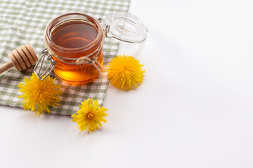 Dandelion honey and fresh flowers. Close up