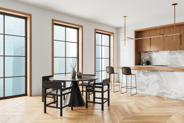 Modern home kitchen interior with bar counter and eating table, window