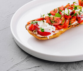 Fresh tomato and cheese bruschetta on plate