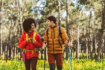 Couple Hiking Together in Forest multiracial