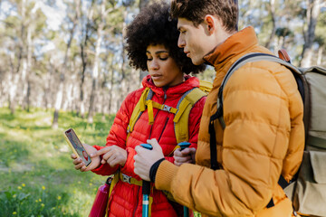 Couple Using GPS on Smartphone for Hiking Navigation