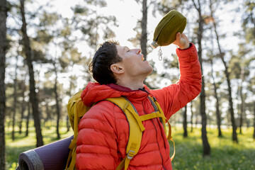 Man Hydrating During Forest Hike