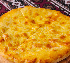 Traditional georgian cheese bread khachapuri on wooden board