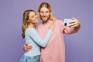 Young couple two friends family man woman wear pink blue casual clothes together do selfie shot on...