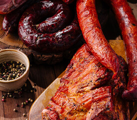 Assortment of smoked meats on wooden board