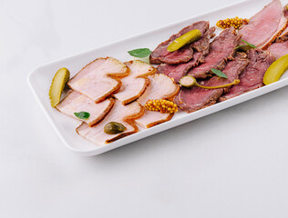 Elegant deli meat platter with sauce