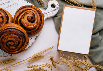 Artisan cinnamon rolls on wooden board with blank box - Powered by Adobe