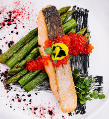 Gourmet salmon dish with caviar and asparagus