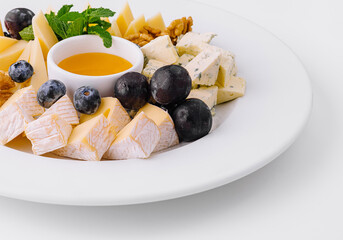 Gourmet cheese platter with honey and fruits