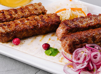 Grilled kebabs platter with sauces and salad