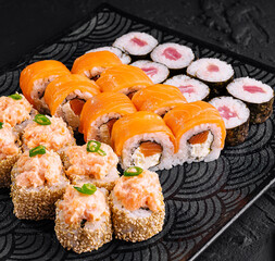 Assorted sushi platter on black slate background