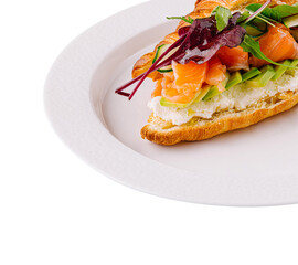 Gourmet smoked salmon croissant sandwich on white