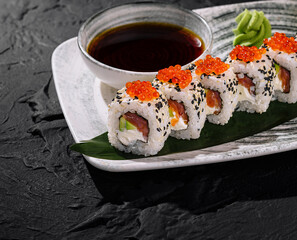 Elegant sushi roll platter with caviar and soy sauce