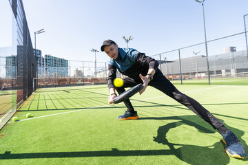 man playing paddle tennis at indoors pitch