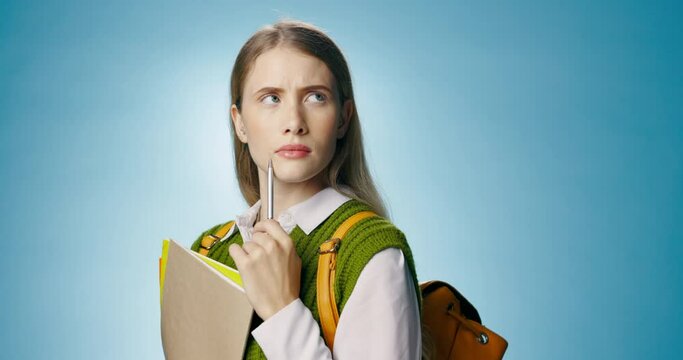 Girl, student and books in studio with thinking, mockup space or choice for education by blue background. Woman, person and backpack with folders for decision, solution or learning for college test