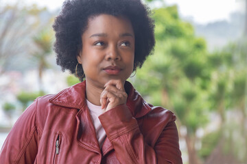 afro hair woman thinking on the street