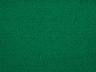 A richly textured green felt surface exudes a sense of warmth and depth, inviting tactile exploration