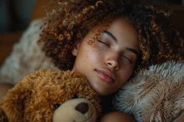 A sleeping woman rests on a pillow in her bedroom, accompanied by a teddy bear