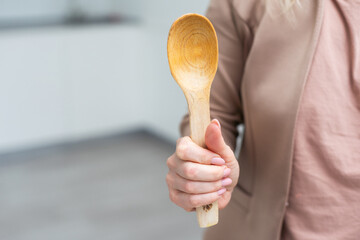 Wooden spoon in hand isolate