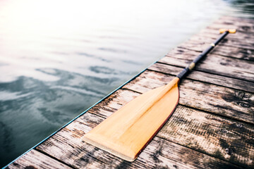 Paddle on wooden dock. Concept of canoeing as dynamic and adventurous sport