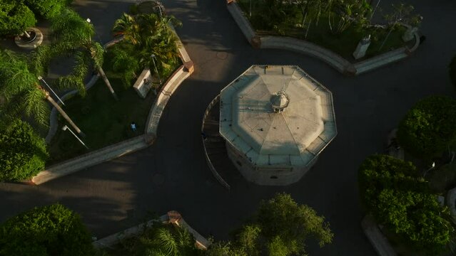 Birds fly over Tamazula de Gordiano, revealing Santuario Diosesano De La Virgen Del Sagrario church in an aerial dolly tilt-up