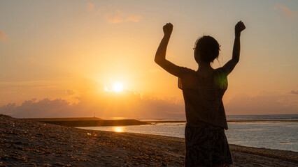Fototapeta premium A silhouette of a person with arms outstretched.