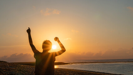 Fototapeta premium A silhouette of a person with arms outstretched.