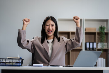 Successful young female businessman, Businesswoman using laptop computer in office. Happy woman,...