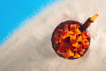 Mangonada, typical mexican mango smoothie on summer background. Top view.