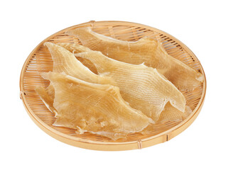 dry stingray fin food isolated cutout on white background in wood plate