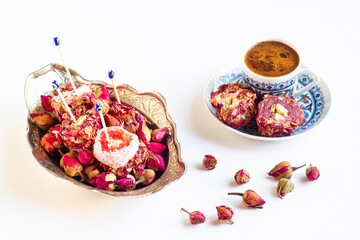 Traditional Turkish Rose Turkish Delight, designed with rosebuds and Turkish coffee on white surface