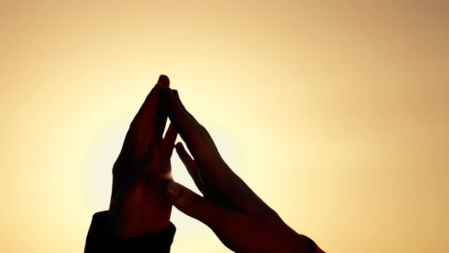 Happy family concept. close-up of two palms together.sign of gratitude. image of the joined hands of man and woman against a background of sunset. trusting relationship. two hands at sunset. teamwork