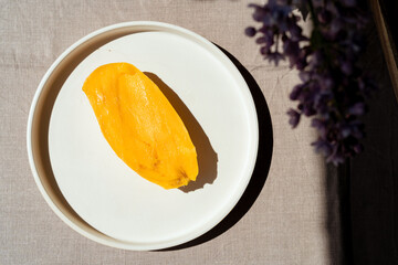 Top view of Fresh Mango on a plate. Juicy and delicious yellow exotic summer fruit