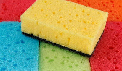 Beautiful background of multi-colored sponges. Bright colored sponges for washing dishes.