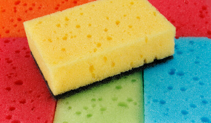 Beautiful background of multi-colored sponges. Bright colored household sponges.