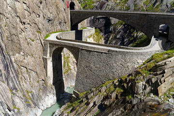 Scenic view of famous Devil's Bridge at Schöllenen Gorge with Reuss River on a sunny late summer...