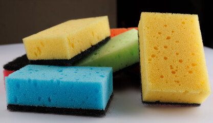 A multi-colored cleaning sponge scattered across the surface. Multi-colored household sponge.