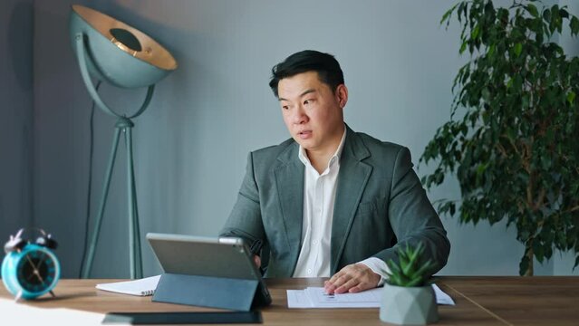 Weary male engrossing in work picking up clock and realizing that still much time left until end of workday. Man watching on passing minutes and finding solace in thoughts about well-deserved rest.