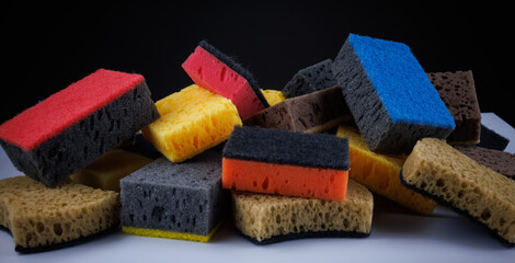 Background of mixed colorful sponges. Household cleaning sponge.