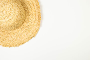 Top view of straw hat on white background. Summer fashion, vacation and beach wallpaper. Copy space, flat lay.