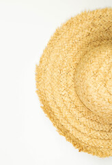 Top view of straw hat on white background. Summer fashion, vacation and beach wallpaper. Copy space, flat lay.